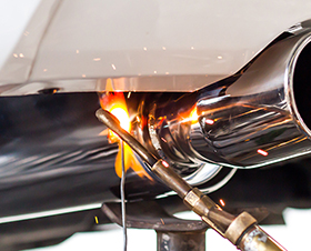 Man checking the engine with voltmeter