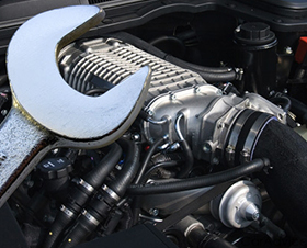 Man doing engine repair with spanner