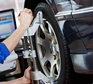 Man doing wheel alignment